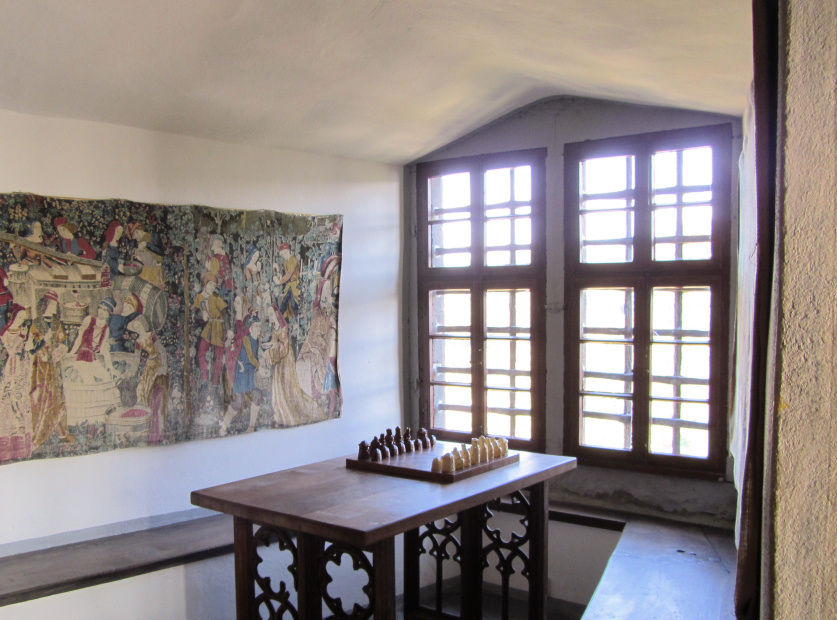 Window seat with tapestry and chess set at the Marksburg, Germany